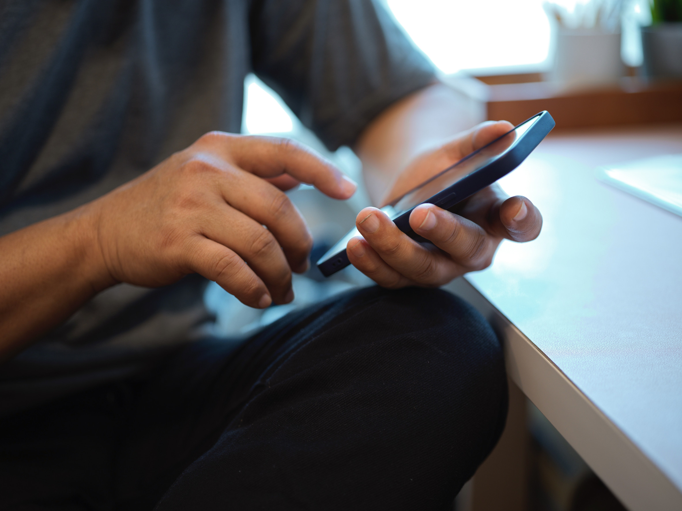 Male hands texting on smart phone