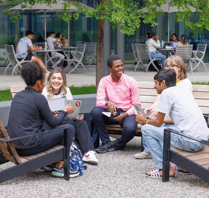 Groups of students socializing and studying on the Benson Terrace at CU Denver