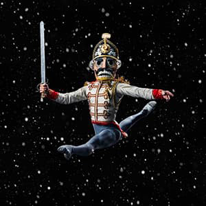 Nutcracker ballet dancer mid-jump in Nutcracker costume, black starry sky background