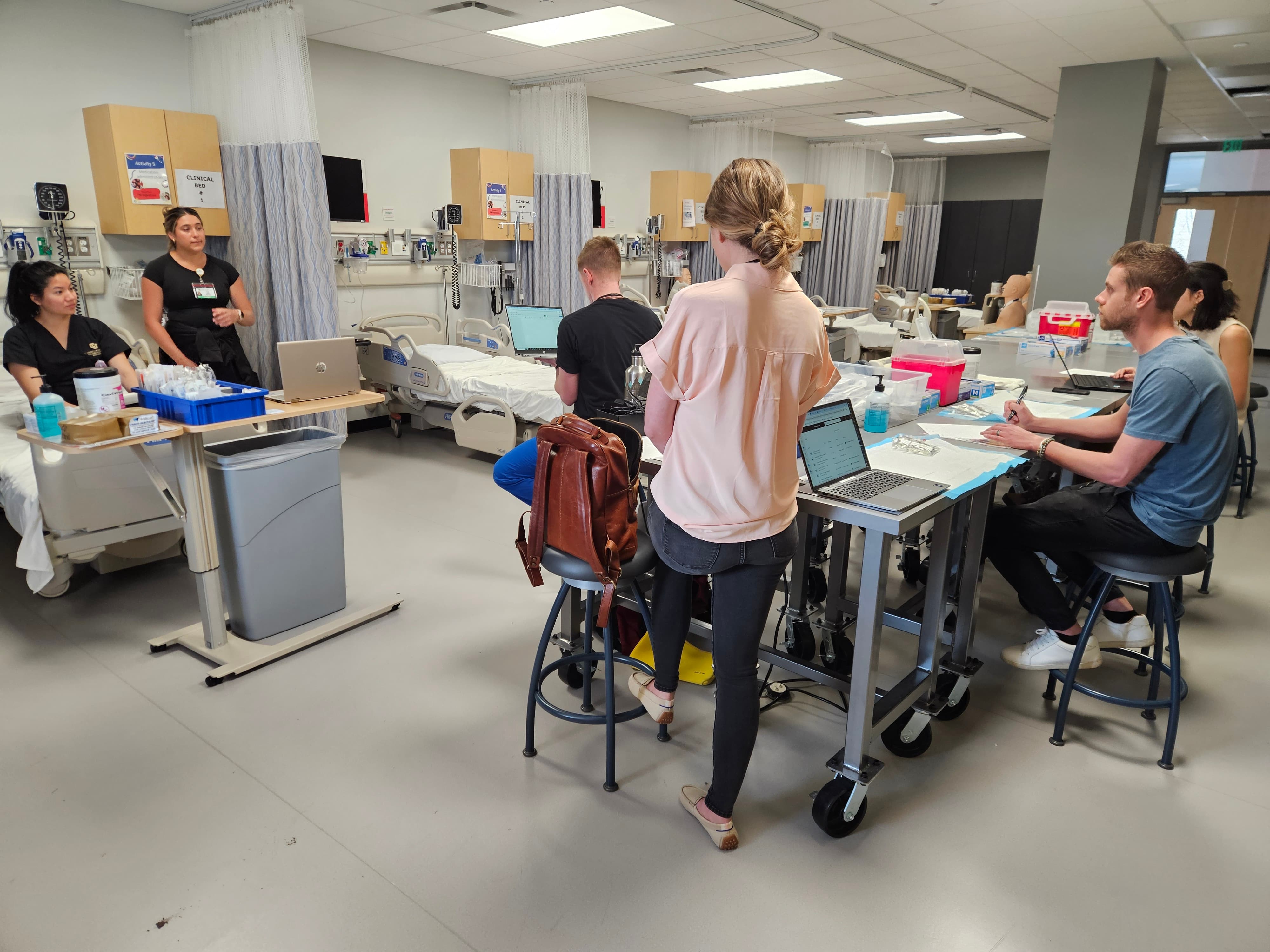 A group of graduate students observe a clinical demonstration