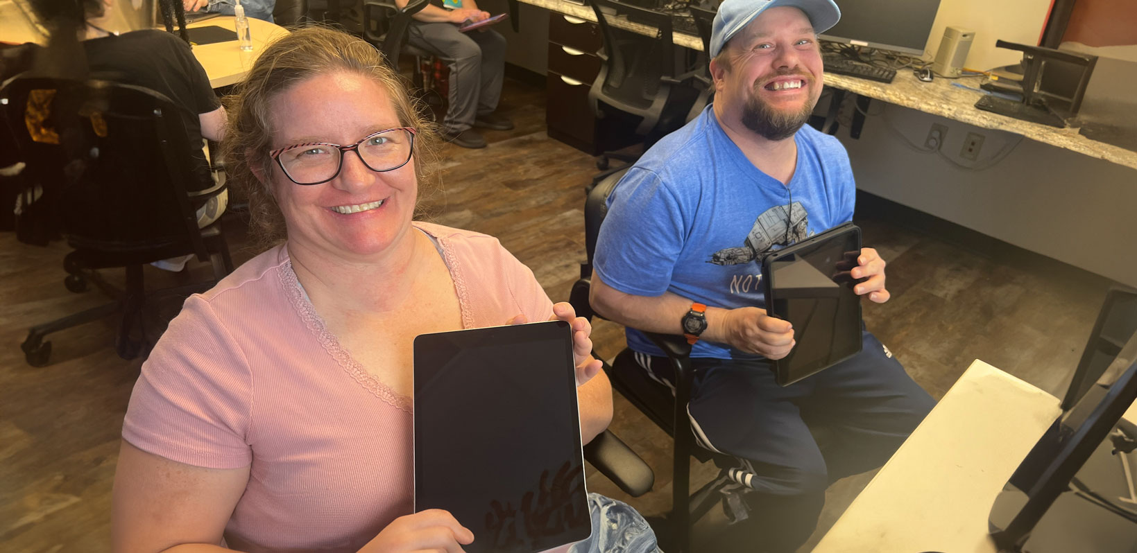 Program participants holding up iPads